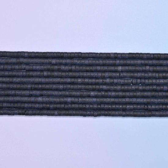 Blue sandstone beads in deep blue with shimmering copper flecks