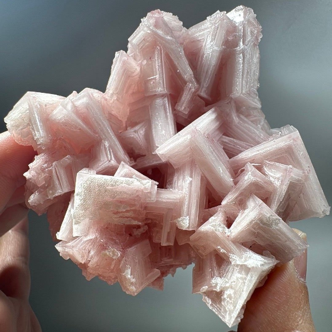 California pink halite mineral specimen, a cluster of stepped hopper crystals in soft rose and blush