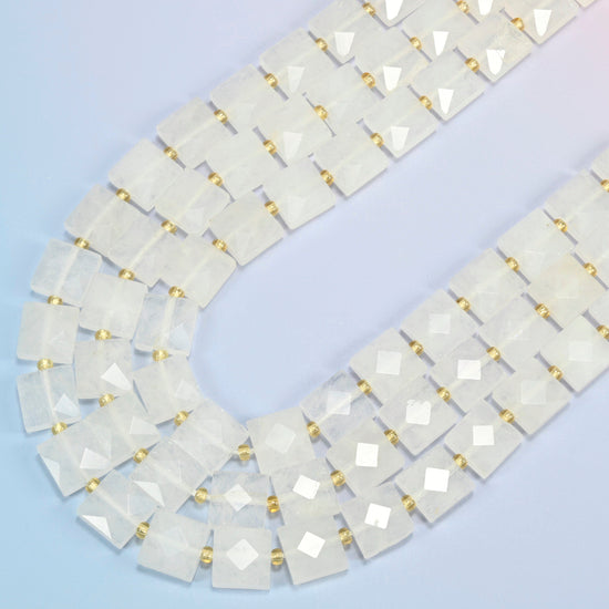 Clear quartz faceted flat square beads in several strands curved into a wide U, milky white translucent stone