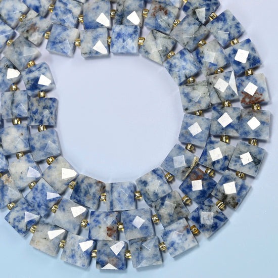 Natural blue spot jasper faceted flat square beads curved into an open loop, white and light gray beads with blue spots