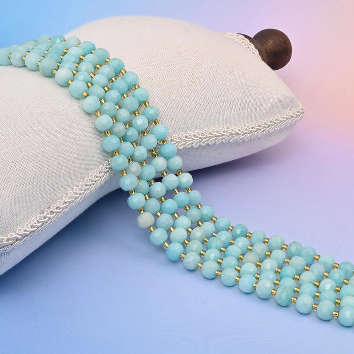Dyed Blue Amazonite Faceted Rondelle Beads in pale sky blue with cream-white patches.