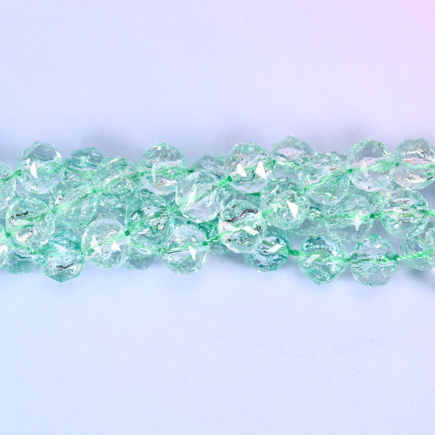 Transparent green faceted round glass beads, approximately 42 beads per strand