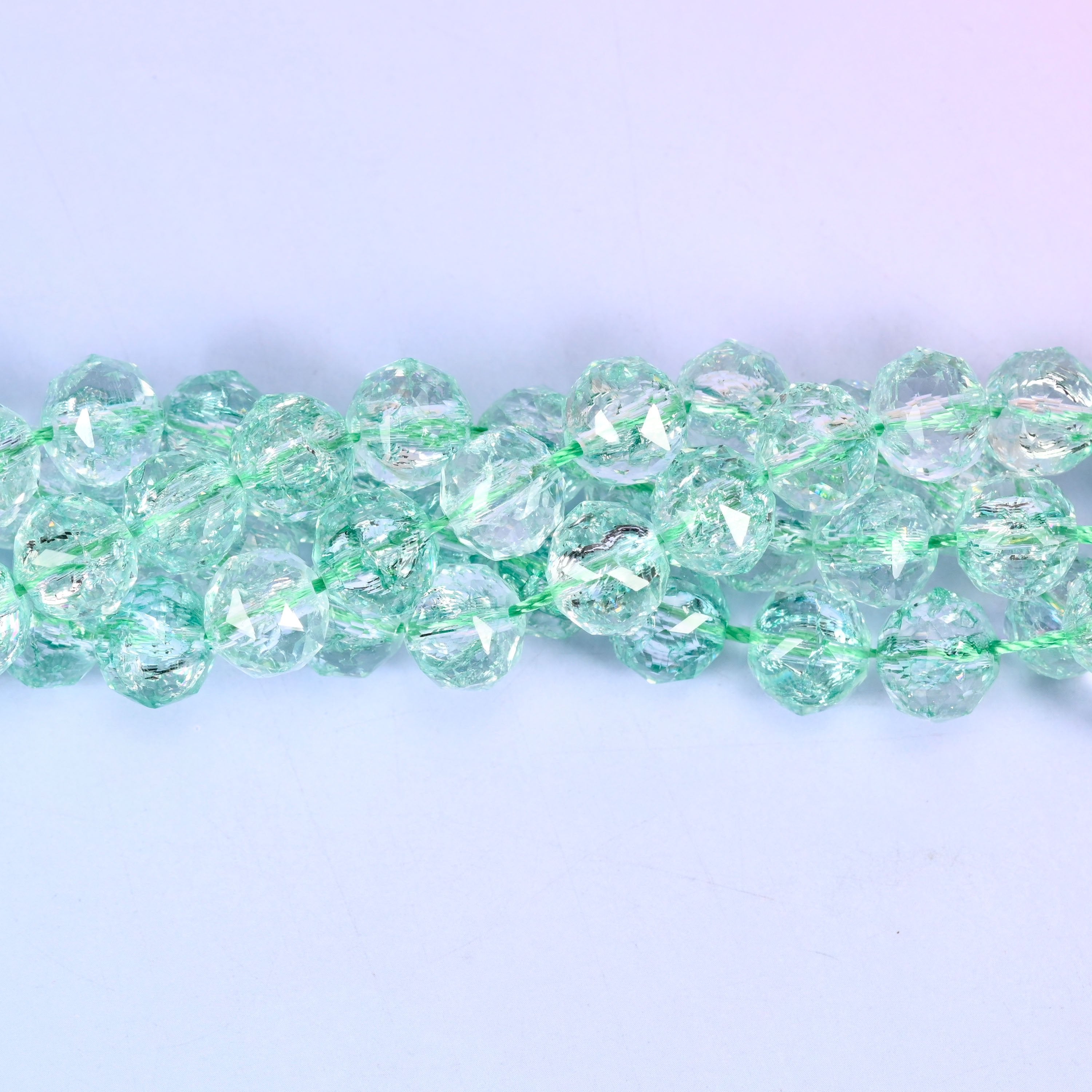 Transparent green faceted round glass beads, approximately 42 beads per strand