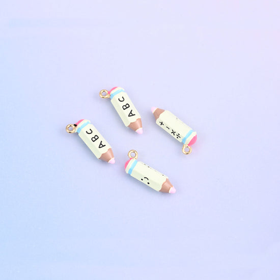 Four light green pencil charms with light blue bands and brown tips.