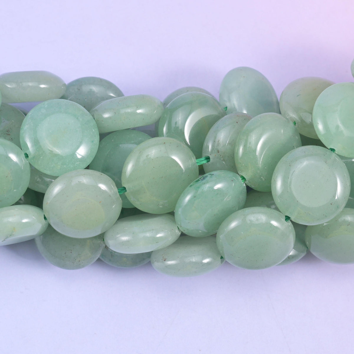 Coin cut Green Aventurine beads with a glassy polished shine