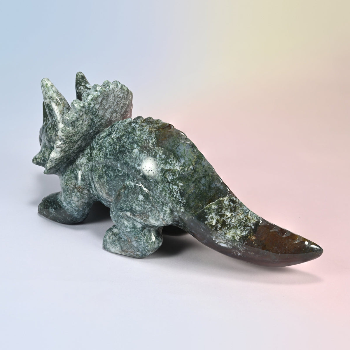 Rear view from the left of the Indian agate triceratops carving, speckled green and white agate