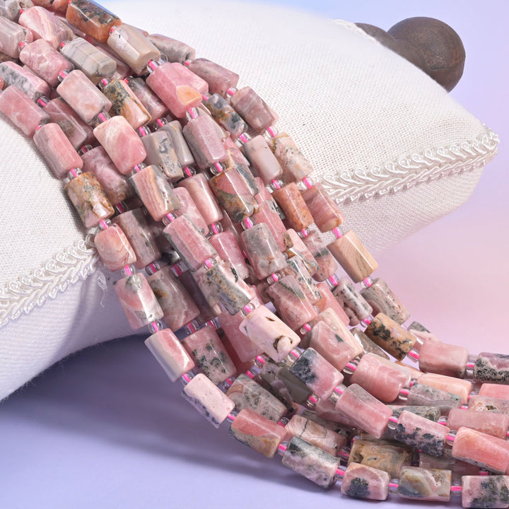 Natural Pink Rhodonite faceted tube beads with soft pink banding patterns.