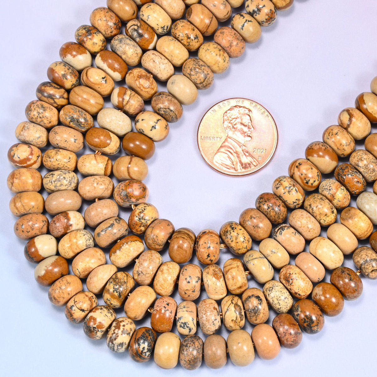 Rondelle cut Natural Picture Jasper beads with natural banding and mineral inclusions.