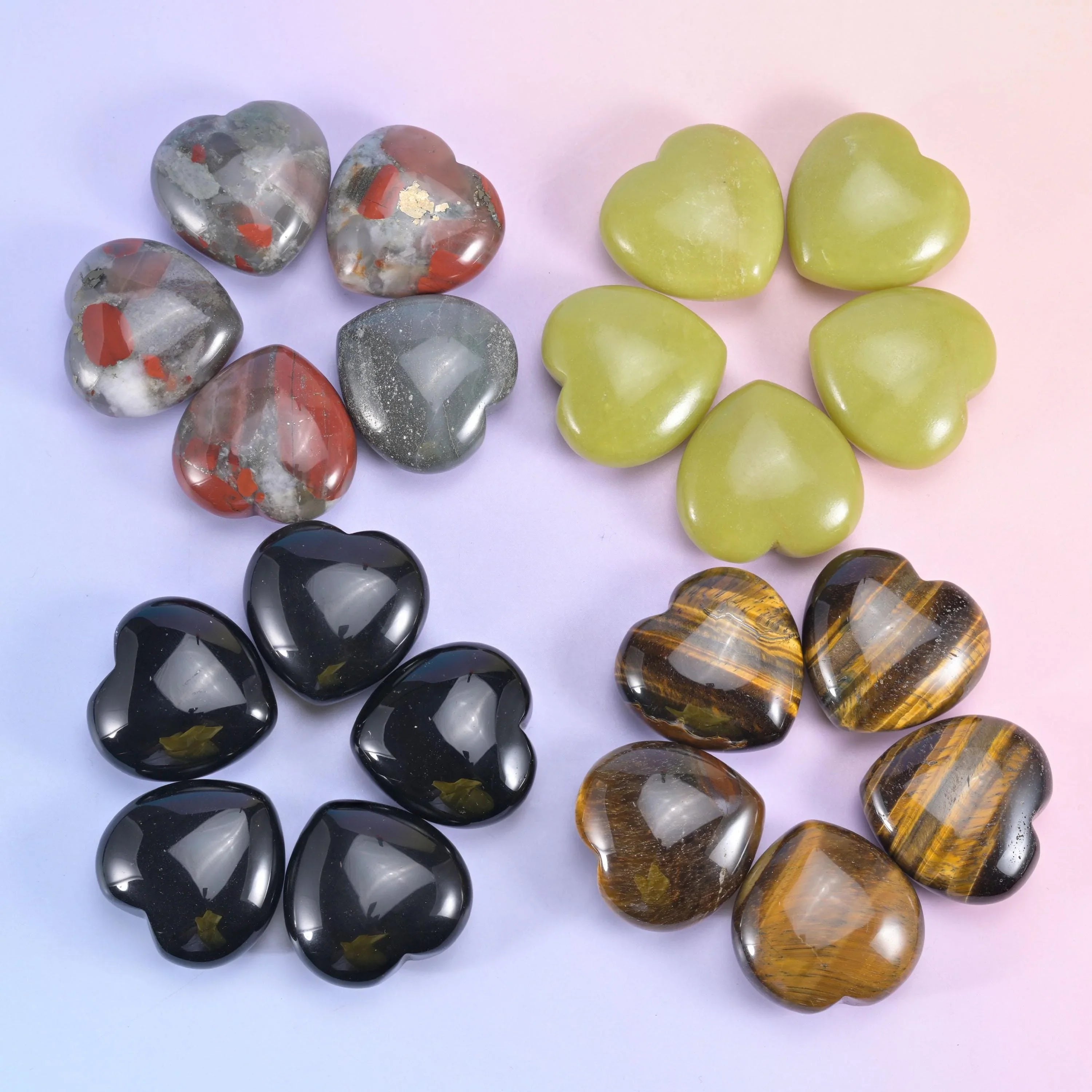 Hearts grouped by stone, olive lemon jade beside black obsidian, banded tiger eye and speckled agate