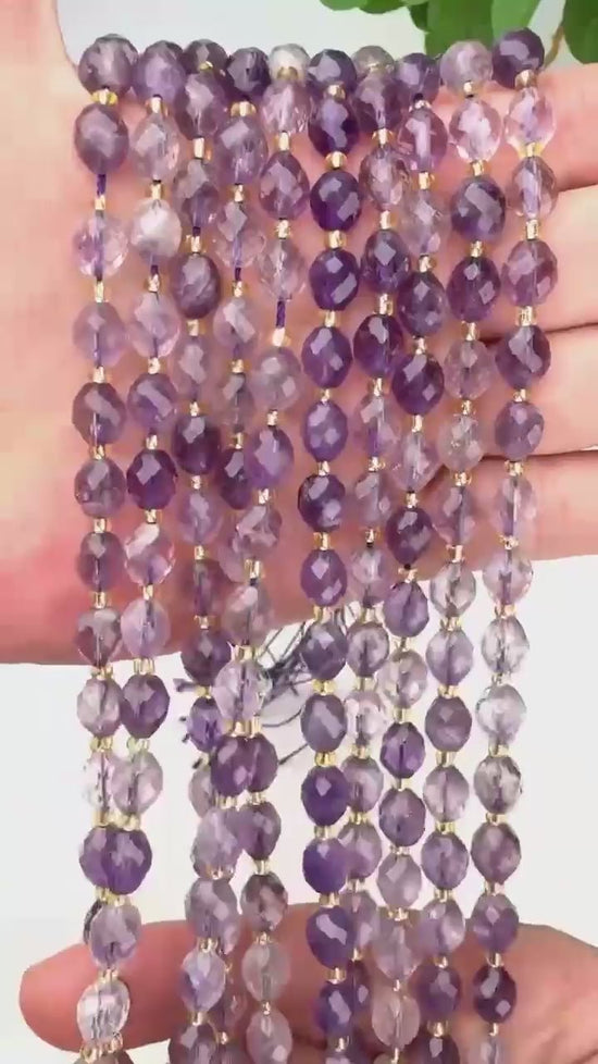 Soft violet barrels shading in and out of clear, with fine golden rutile needles caught inside