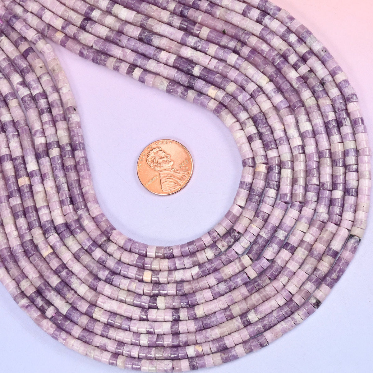 Natural Lepidolite smooth heishi disc beads in soft lilac and lavender tones with delicate mica shimmer, finished with a polished, sophisticated look.