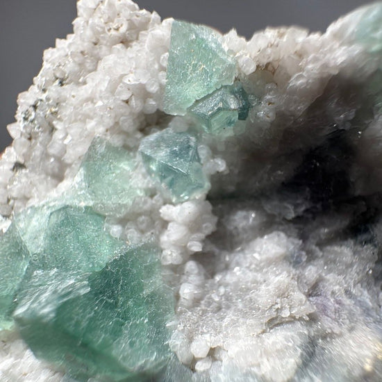 Macro of the crystal pocket, sharp green fluorite edges against sparkling white quartz