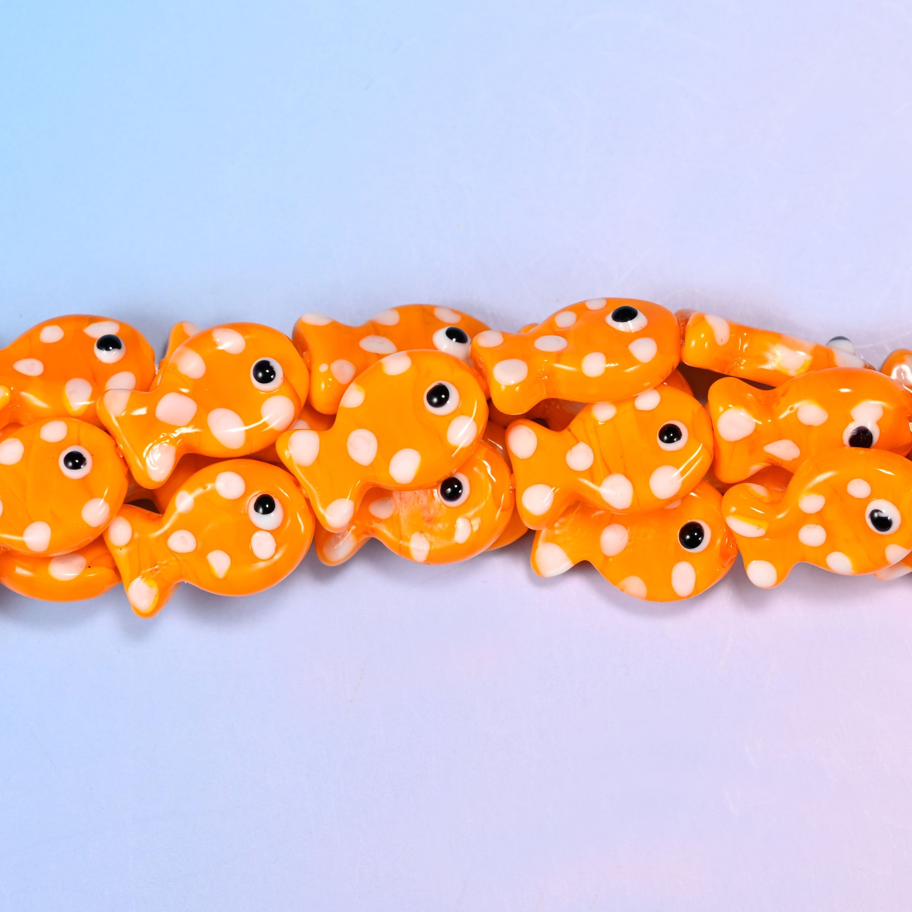 Orange with White Dot Fish Glass Beads, a warm tangerine fish in opaque glossy glass freckled with white dots