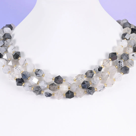 Faceted Diamond Cut Gemstone Beads 10mm in varies by stone — clear quartz threaded with smoky black needles, warm orange…