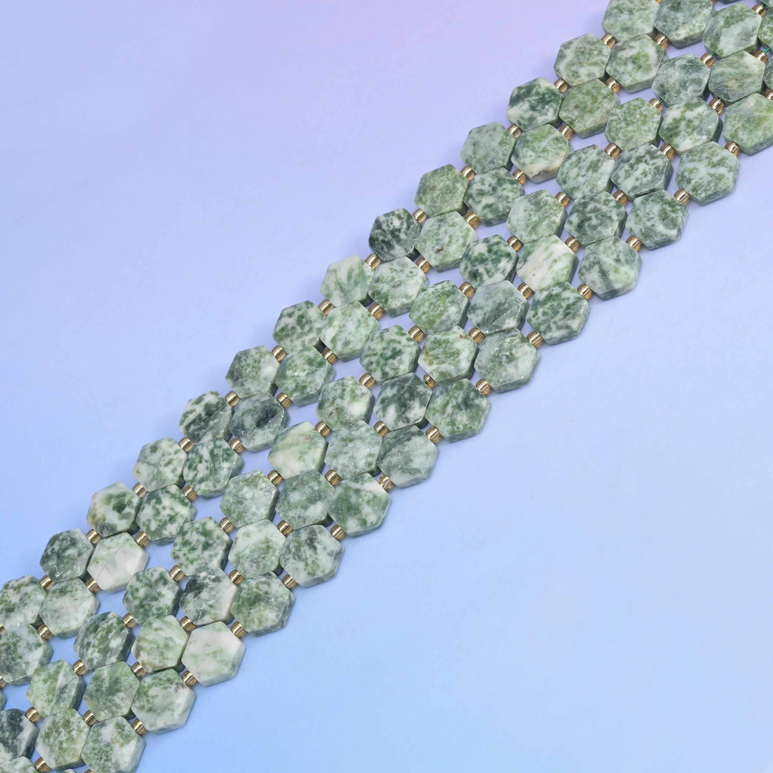 Moss Tree Agate in pale celadon with dark green dendritic markings.