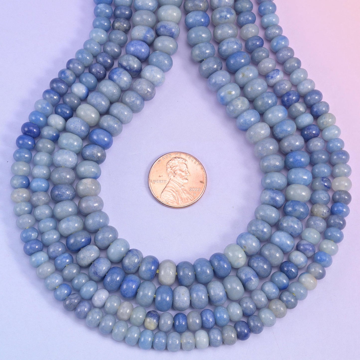 Powder blue deepening to navy across the strand, cut as smooth rondelles and polished until the surface turns glassy. Blue Aventurine in a shape that stacks tight and strings fast.
