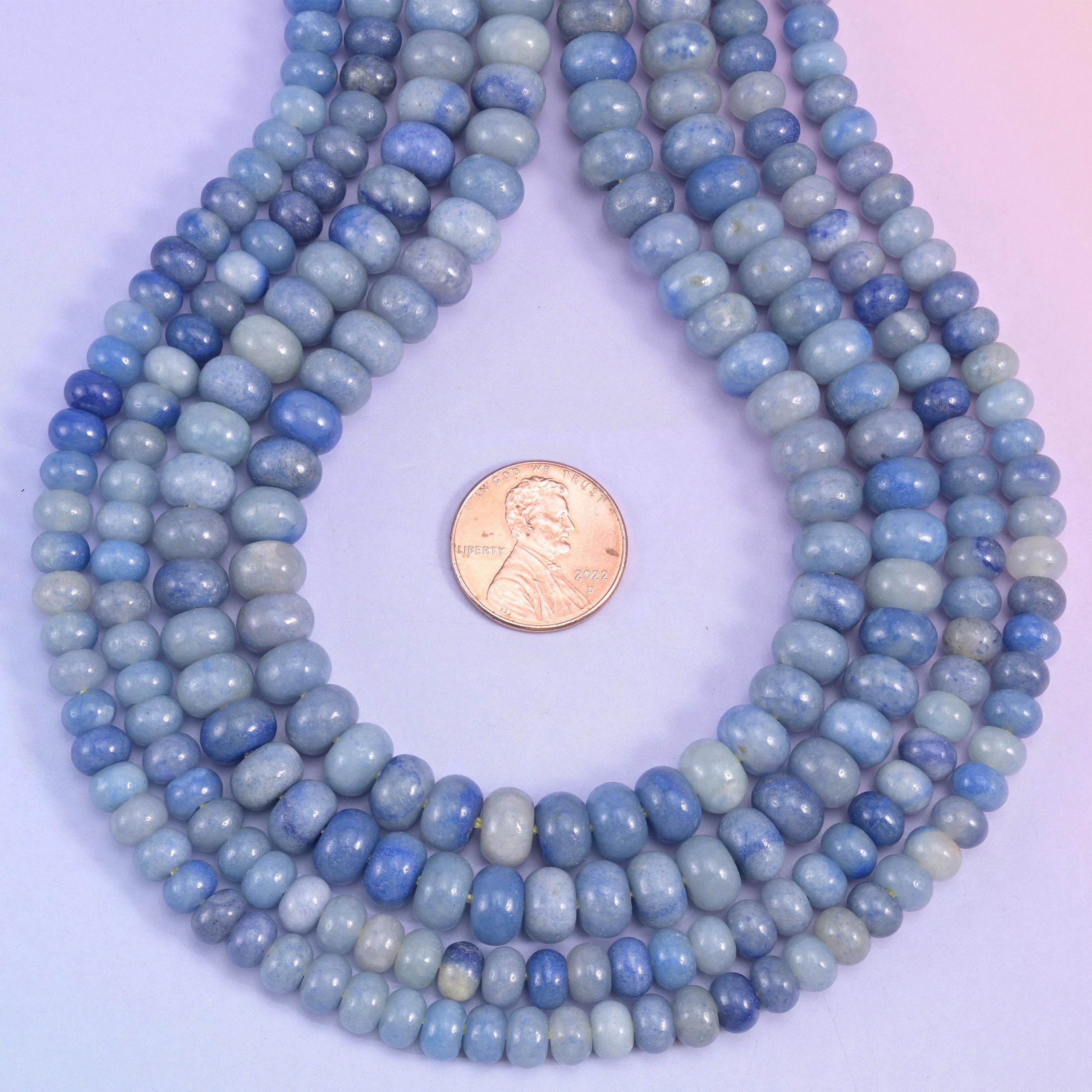 Powder blue deepening to navy across the strand, cut as smooth rondelles and polished until the surface turns glassy. Blue Aventurine in a shape that stacks tight and strings fast.