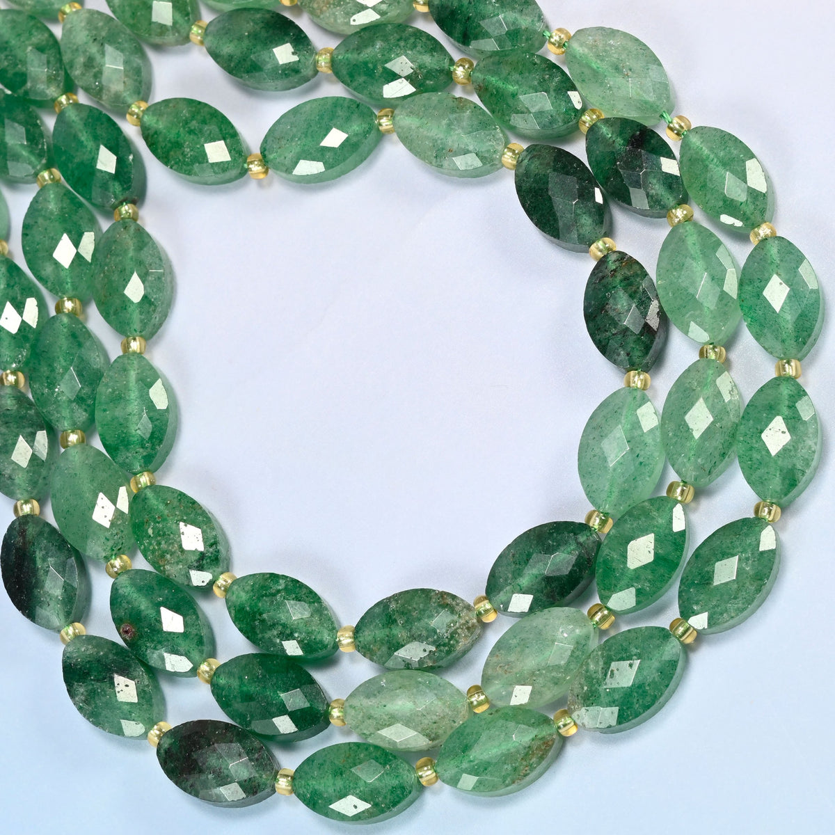 Green strawberry quartz faceted flat oval beads curved into an open loop, emerald and forest green beads