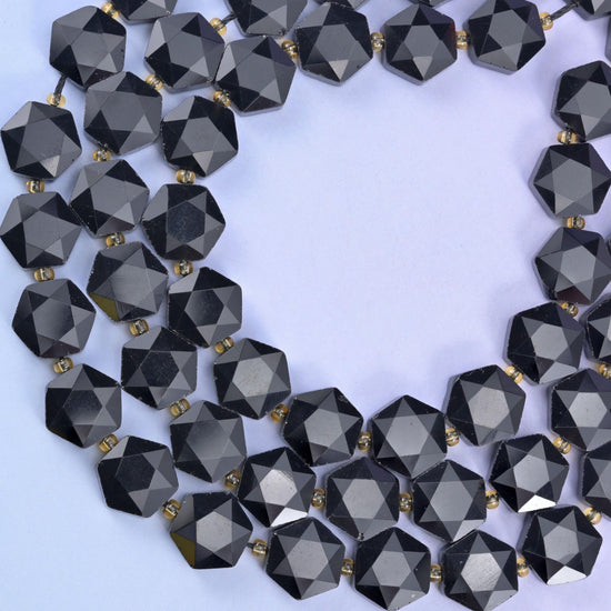 Open circle of black obsidian hexagons on pale lilac, facets bright against the flat faces