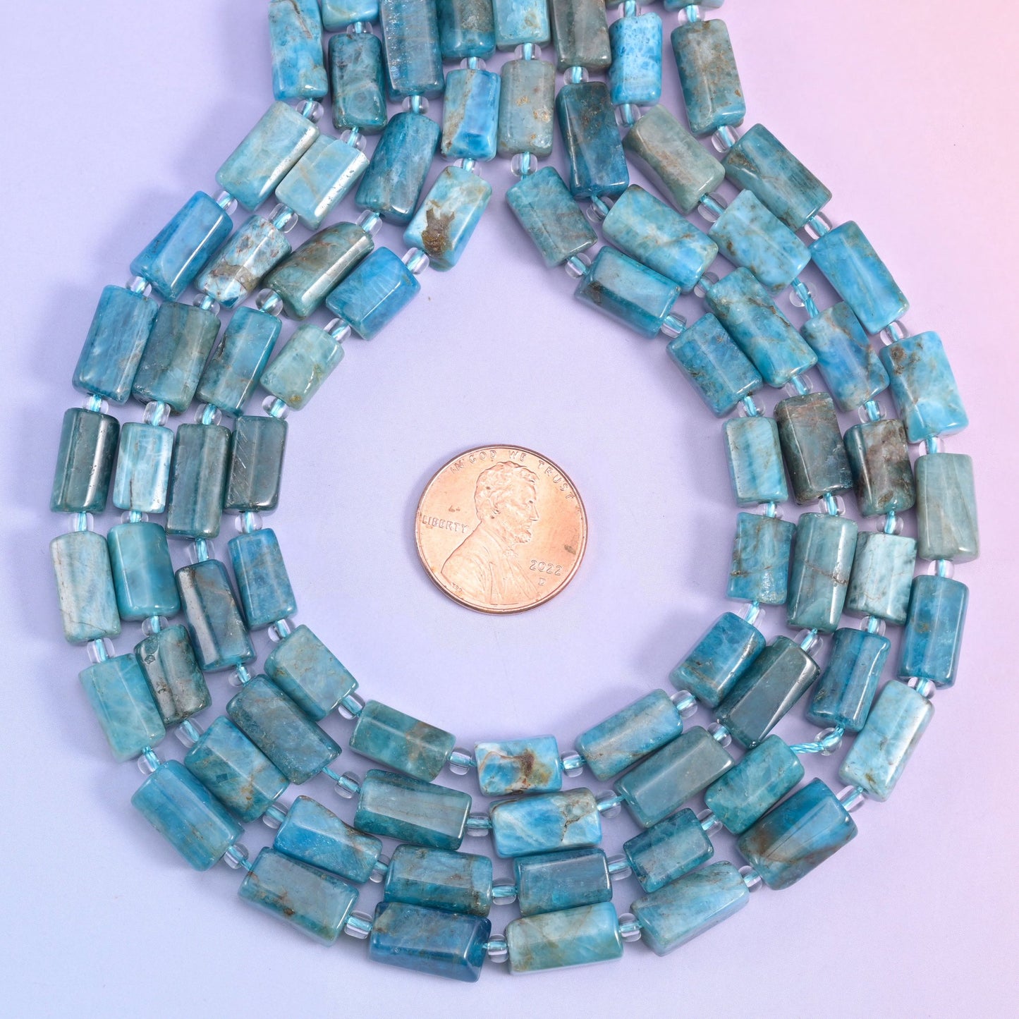 A sleek, polished tube shape with natural color variation, perfect for handmade jewelry designs