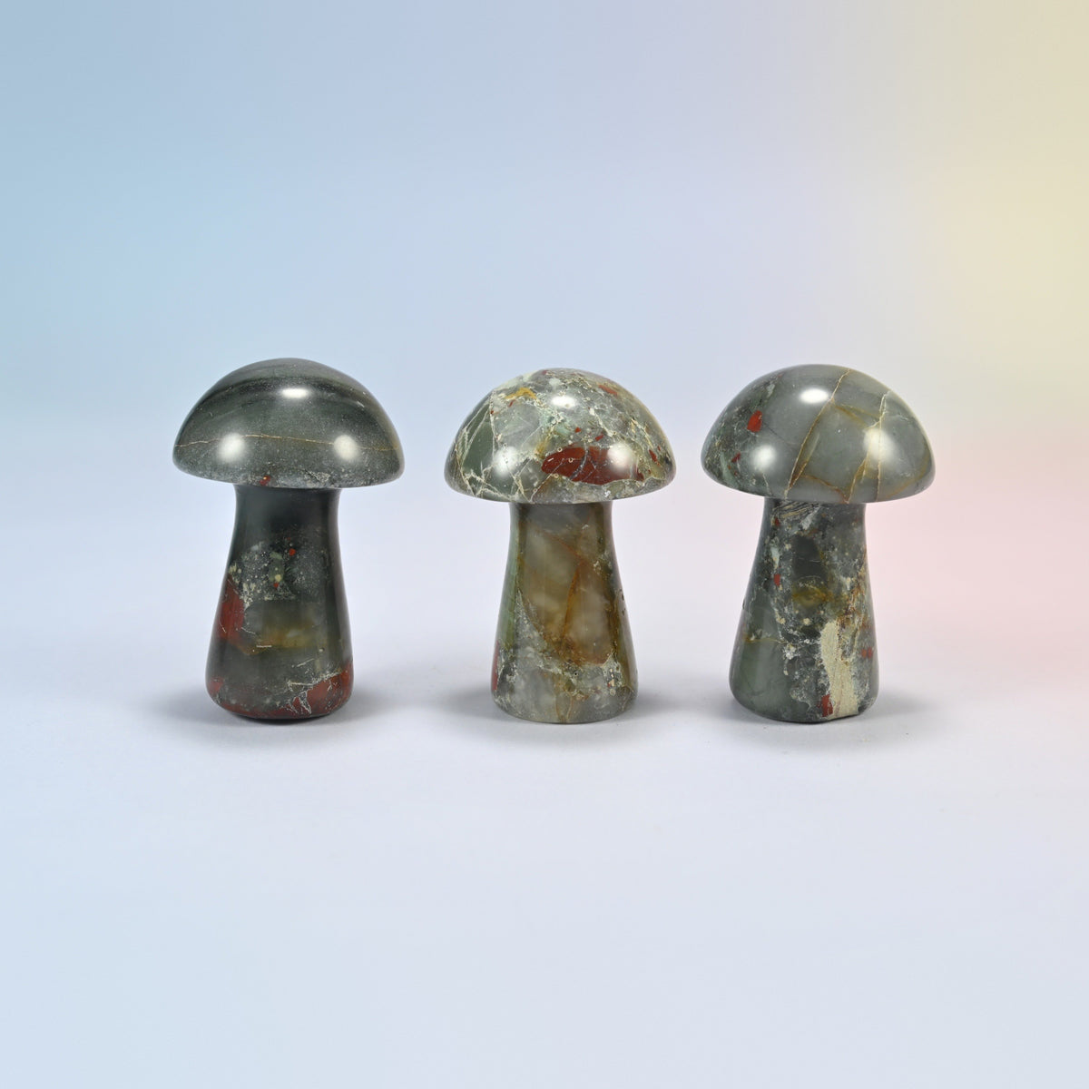 Three 2 inch African bloodstone mushroom crystal carvings, gray-green natural stone with red patches