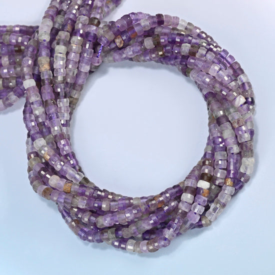 Amethyst faceted heishi disc beads coiled into overlapping loops, whole strands of purple and lavender stone