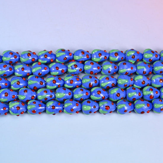 Dark Blue Red Dots Strawberry Glass Beads in glossy cobalt blue with a pale green leaf cap