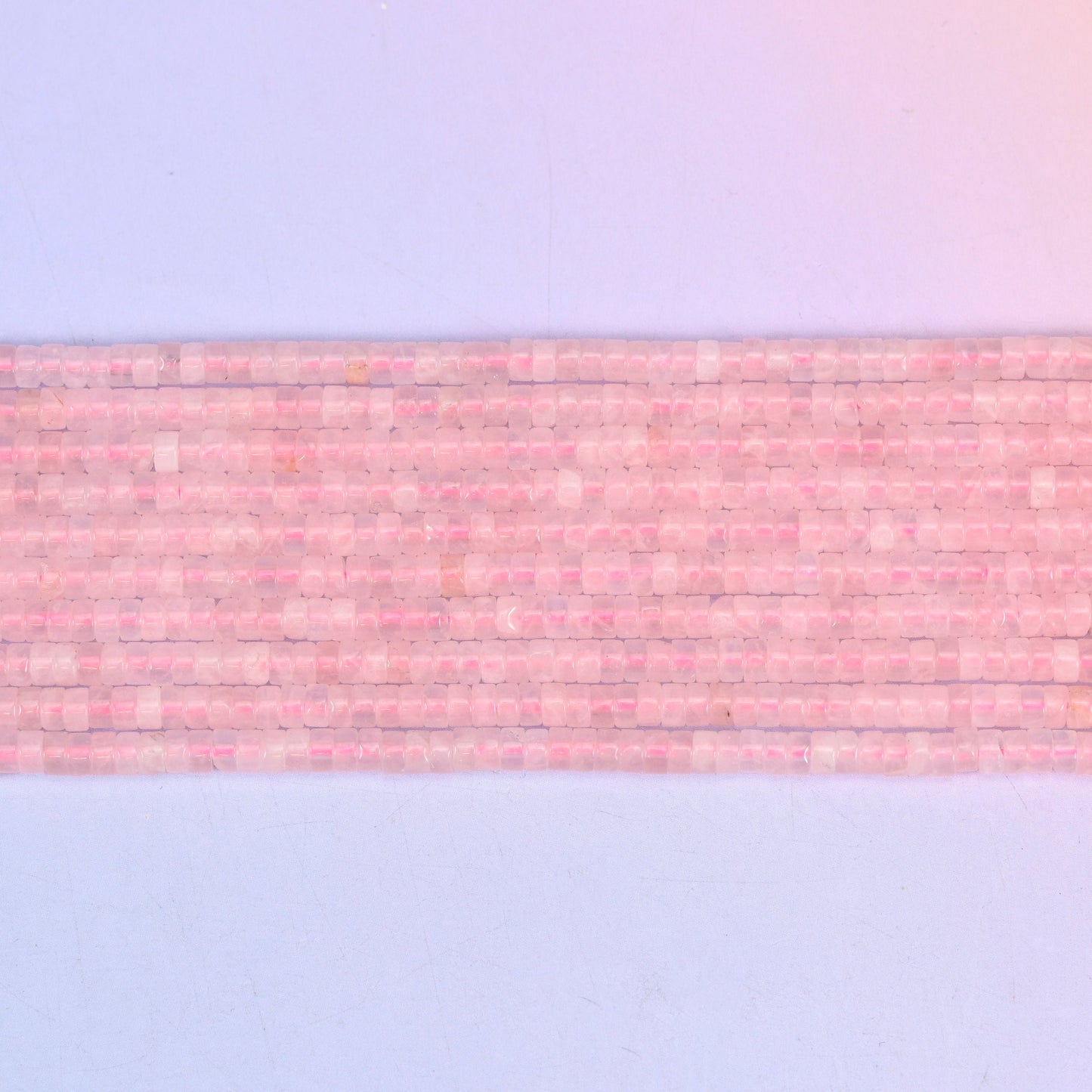 Rose Quartz Smooth Heishi Disc Beads in soft to vivid pink with a translucent glow