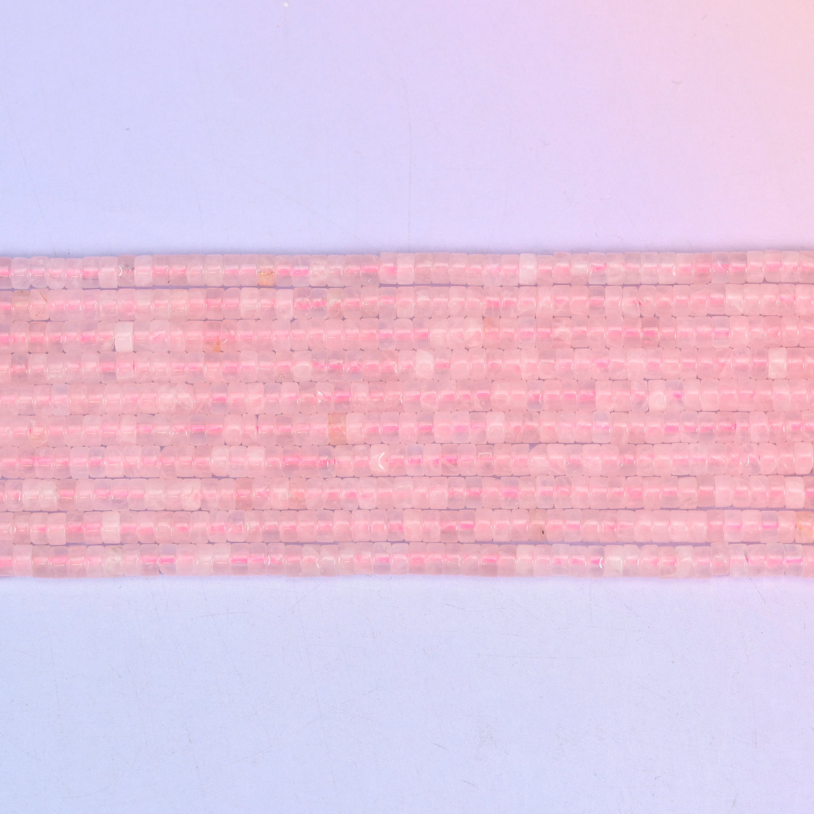 Rose Quartz Smooth Heishi Disc Beads in soft to vivid pink with a translucent glow