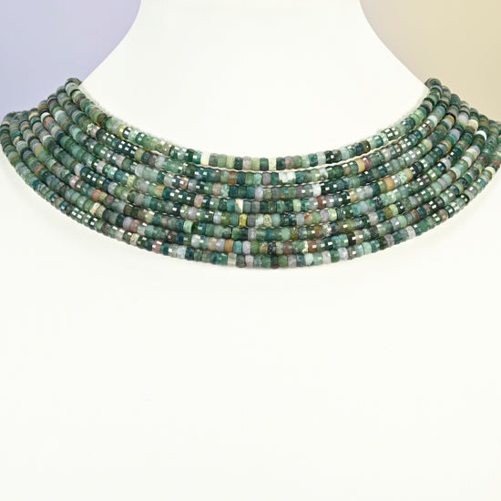 Indian agate faceted heishi disc strands arranged as a layered collar on a white display bust, green beads across the neck