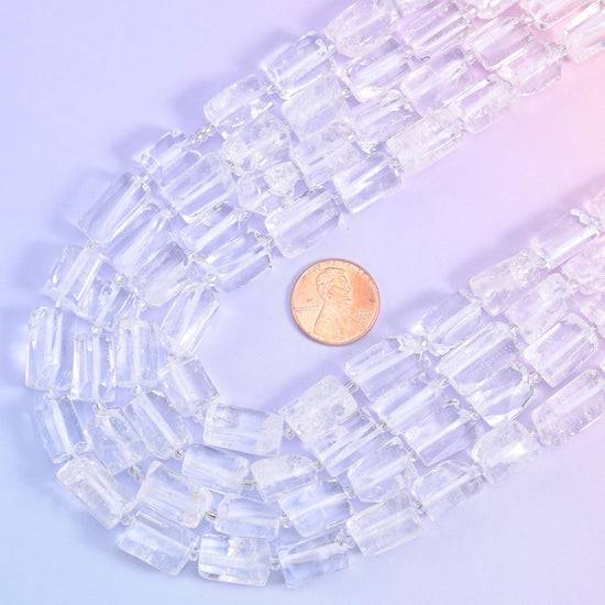 A US penny tucked into the curve of the strands gives the scale of the 14x9mm quartz tubes