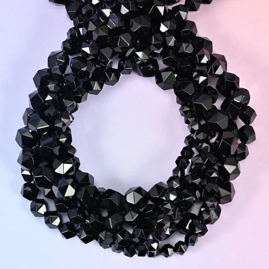 Black Onyx star cut beads coiled in a loop, approximately 38 beads per 10mm strand