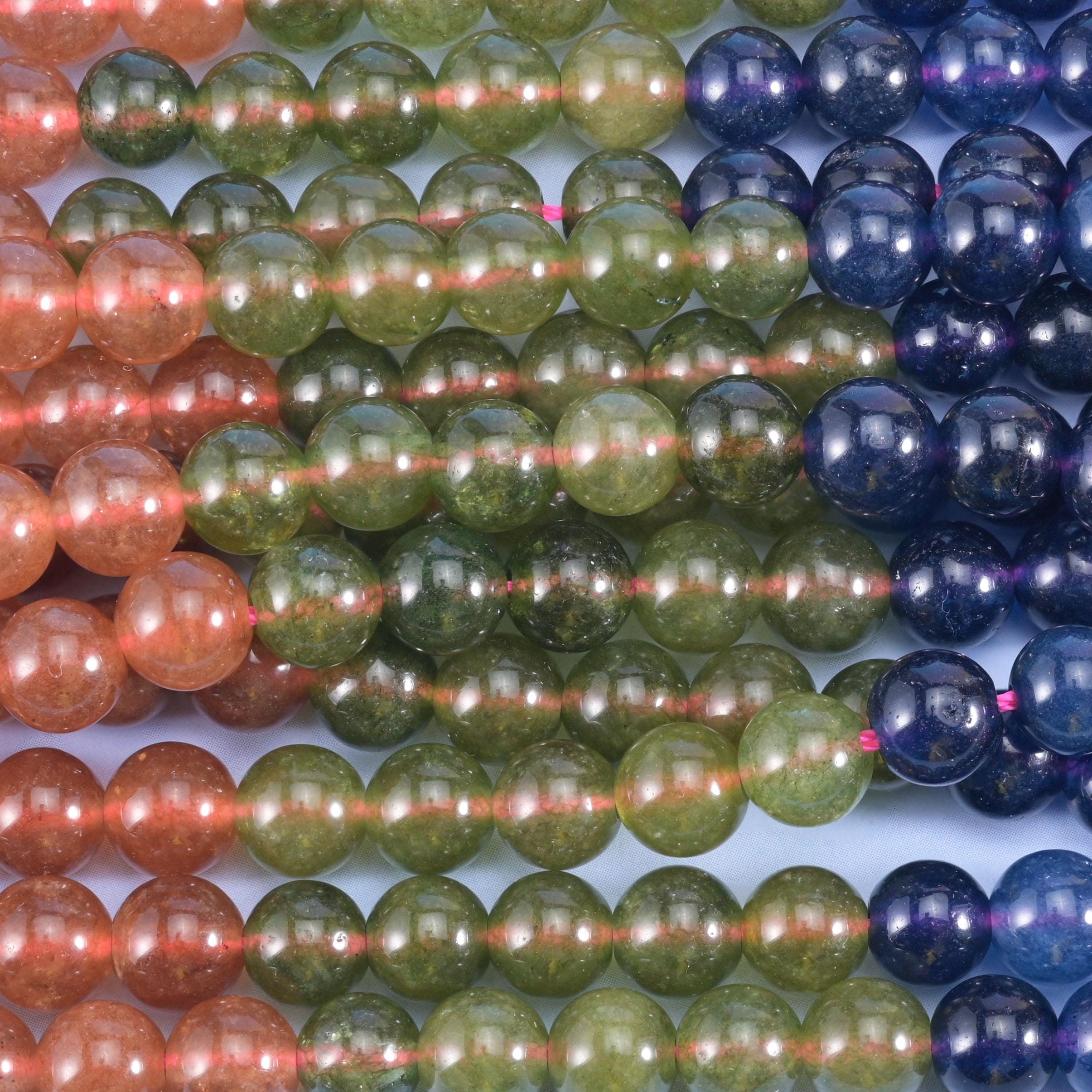 Jade rounds dyed in rich tourmaline shades, each strand a single even colour