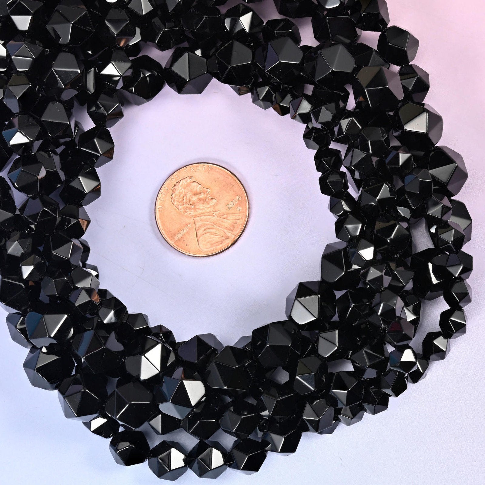 Black Onyx beads coiled around a US penny, hole size approximately 1.0mm, natural stone in solid black