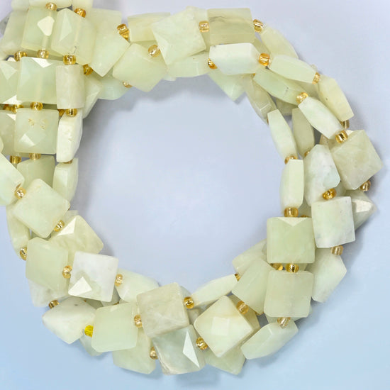 New Jade faceted flat square beads coiled into overlapping loops, whole strands of soft yellow-green stone