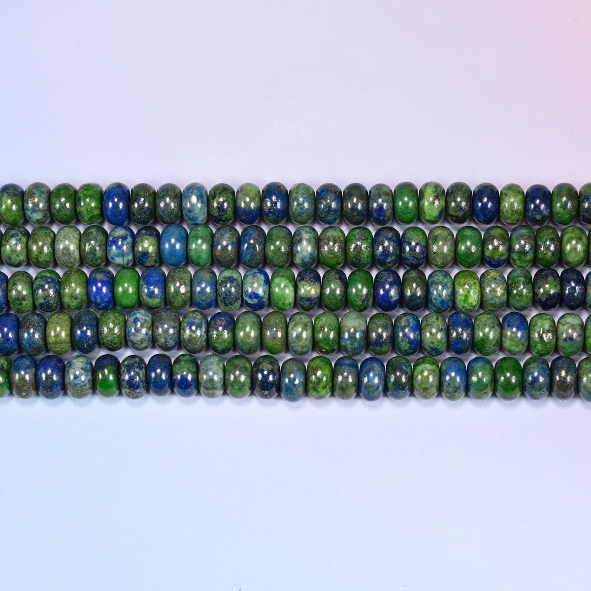 Natural Phoenix Lapis Rondelle Beads in deep blue and moss green with pyrite flecks.