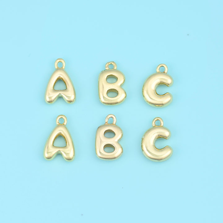 18K gold filled letter pendants, the initials A, B and C in puffed balloon-style gold, shown in two rows.