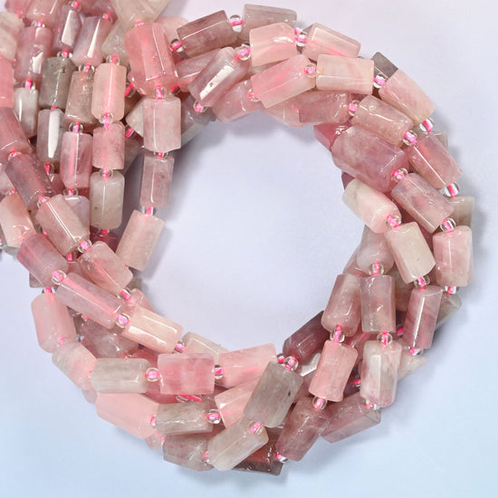 Madagascar multi color rose quartz faceted tube beads coiled in overlapping loops, milky pink and gray-mauve stone.