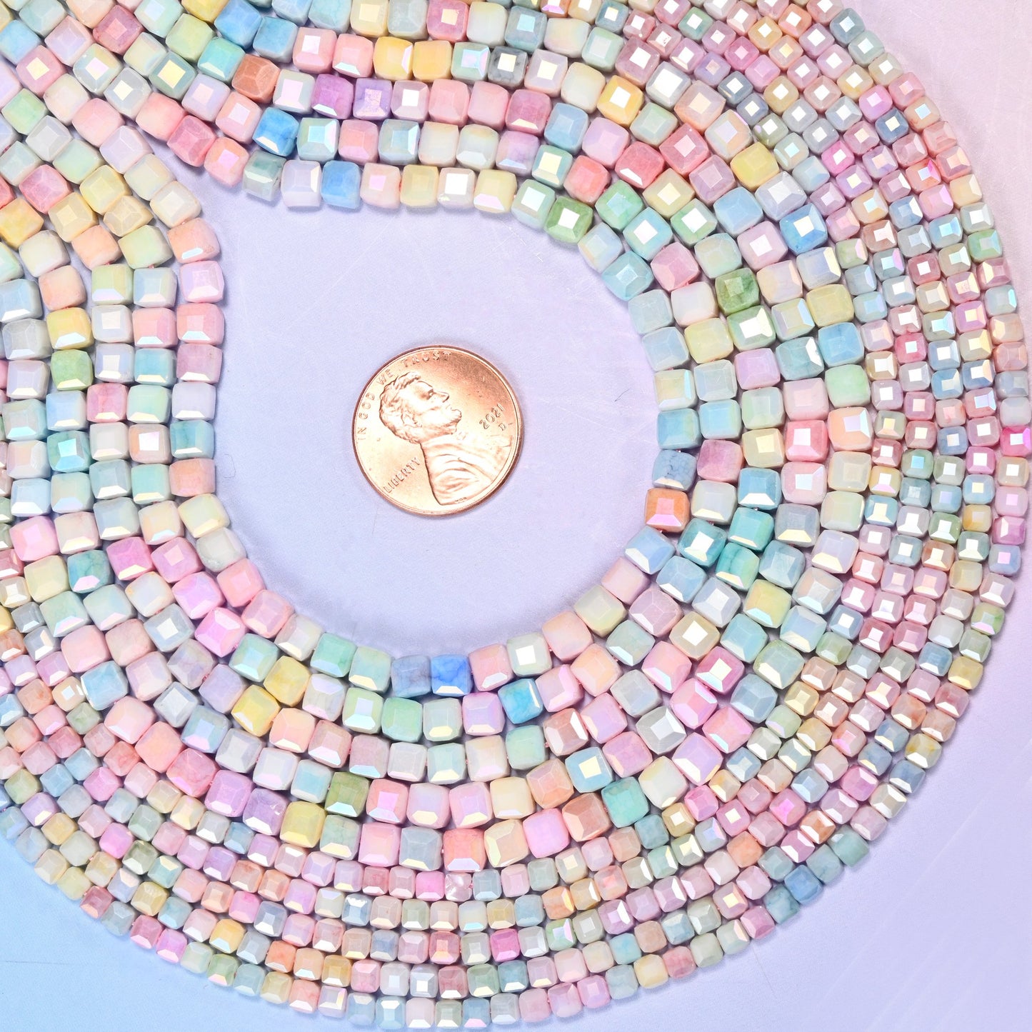 Pastel cube glass beads with a pearly satin sheen on the cut edges.