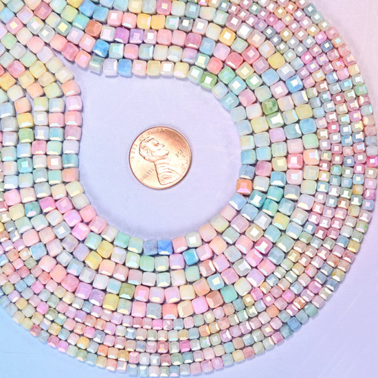 Pastel cube glass beads with a pearly satin sheen on the cut edges.