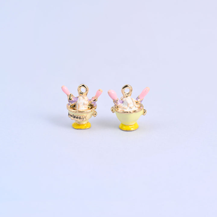 Light yellow ice cream charm shown front and back, footed sundae coupe with a light purple topping.
