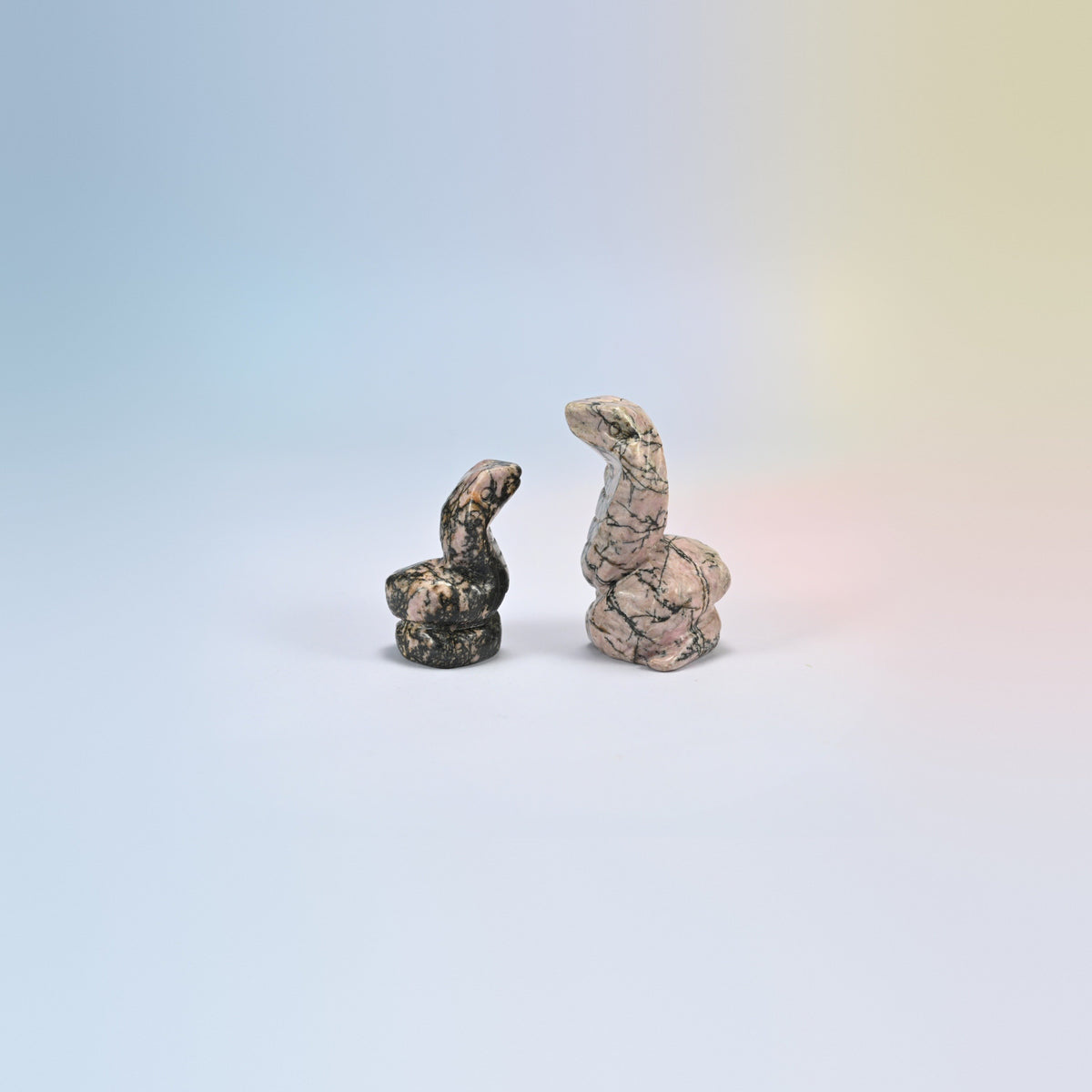 Cobra snake crystal carving in rhodonite, pink natural stone with black veining