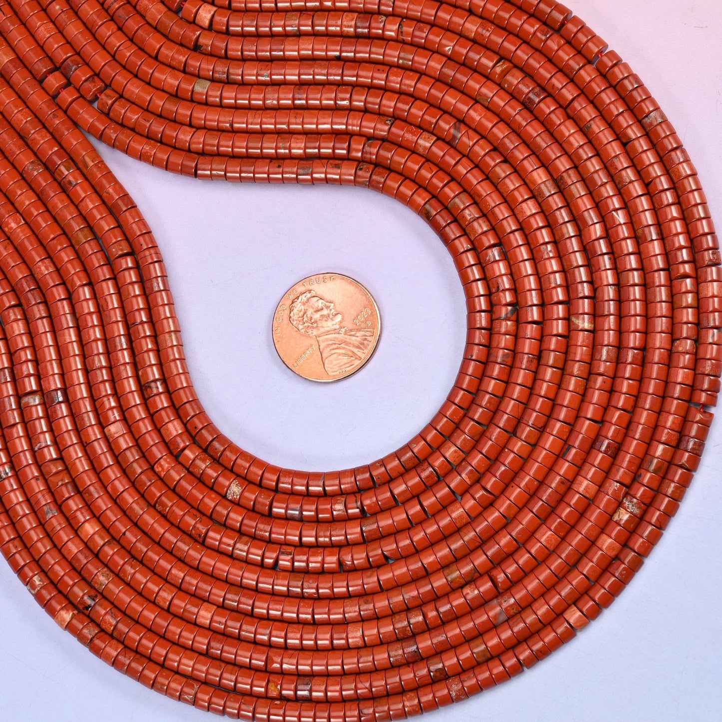 Natural Red Jasper smooth heishi disc beads in a rich brick-red with subtle earthy inclusions, finished with a polished, sophisticated look.