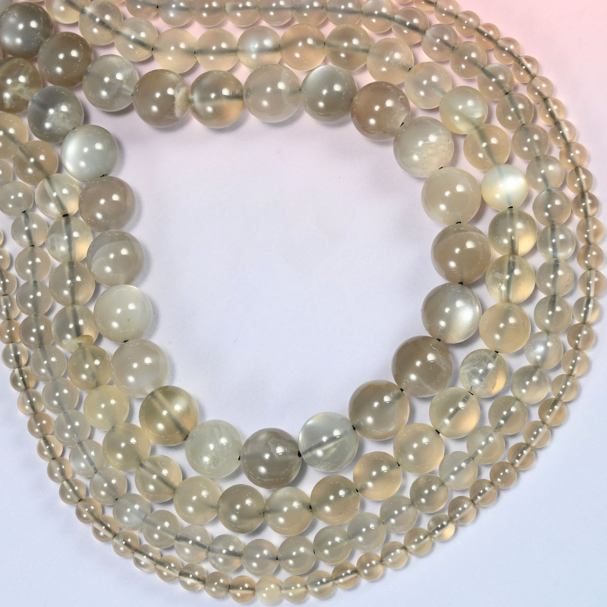AAA Gray Labradorite smooth round beads curved into a wide open loop, a soft white sheen drifting across the beads