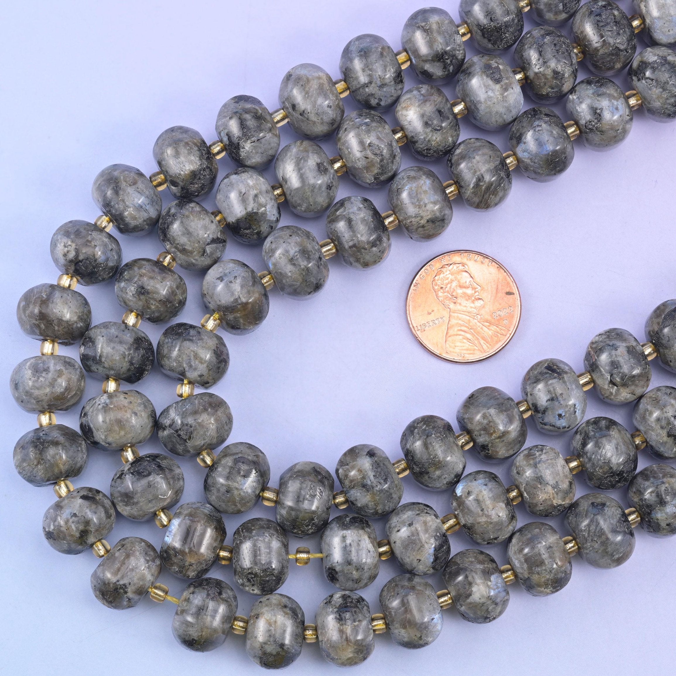 Pumpkin rondelle strands looped around a US penny to show the 12x8mm bead scale