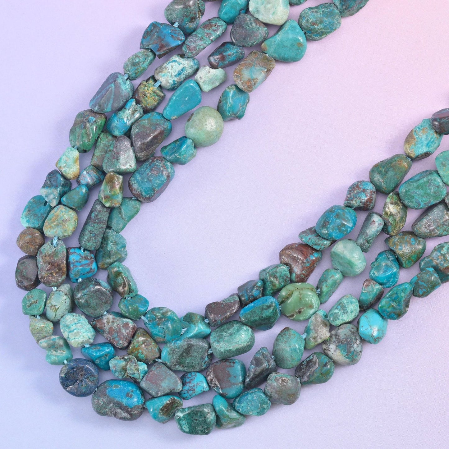 Curved rows of turquoise nuggets, polished tops catching light against the matte matrix lines