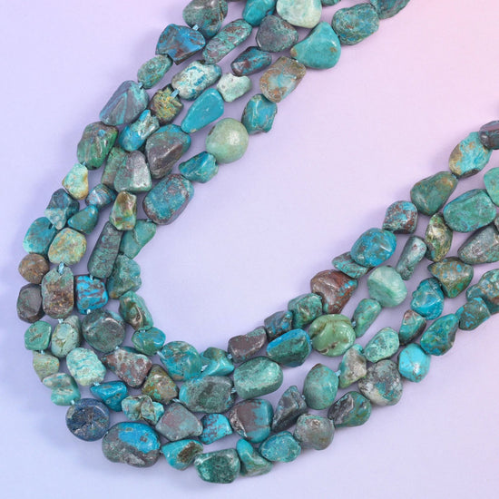 Curved rows of turquoise nuggets, polished tops catching light against the matte matrix lines