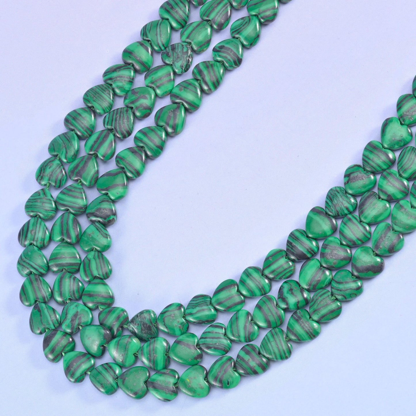 Heart cut Malachite beads with concentric banding
