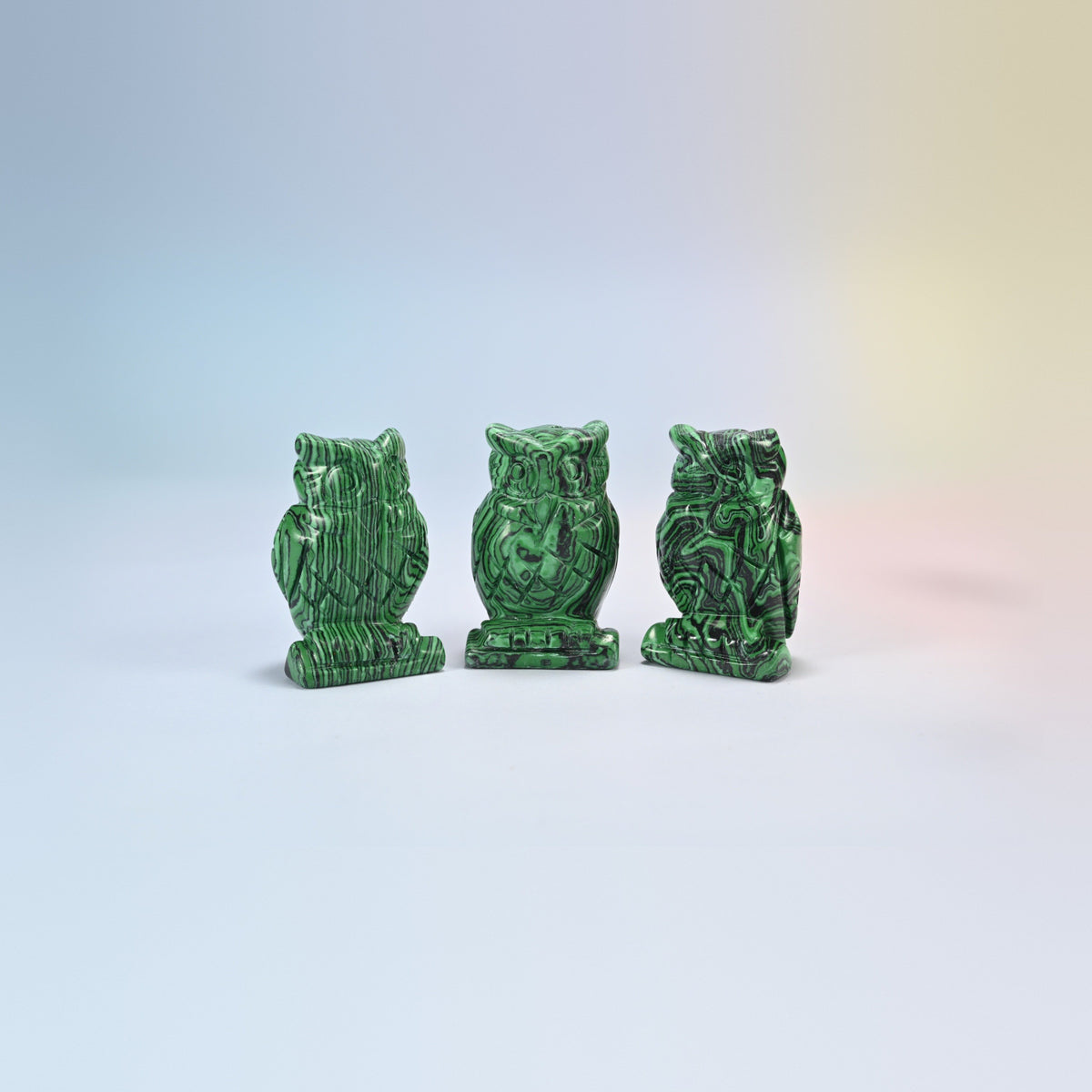 Owl crystal carving in reconstructed malachite, man-made green and black banded stone