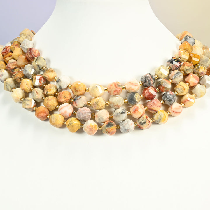 Crazy agate faceted spiral twist beads on a white neck display, four strands around the base of the bust.